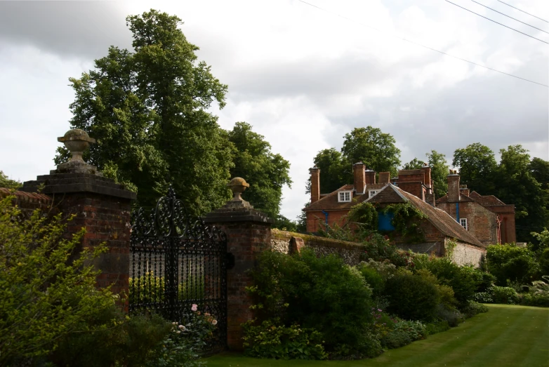 an iron gate and wrought iron fence in a walled area