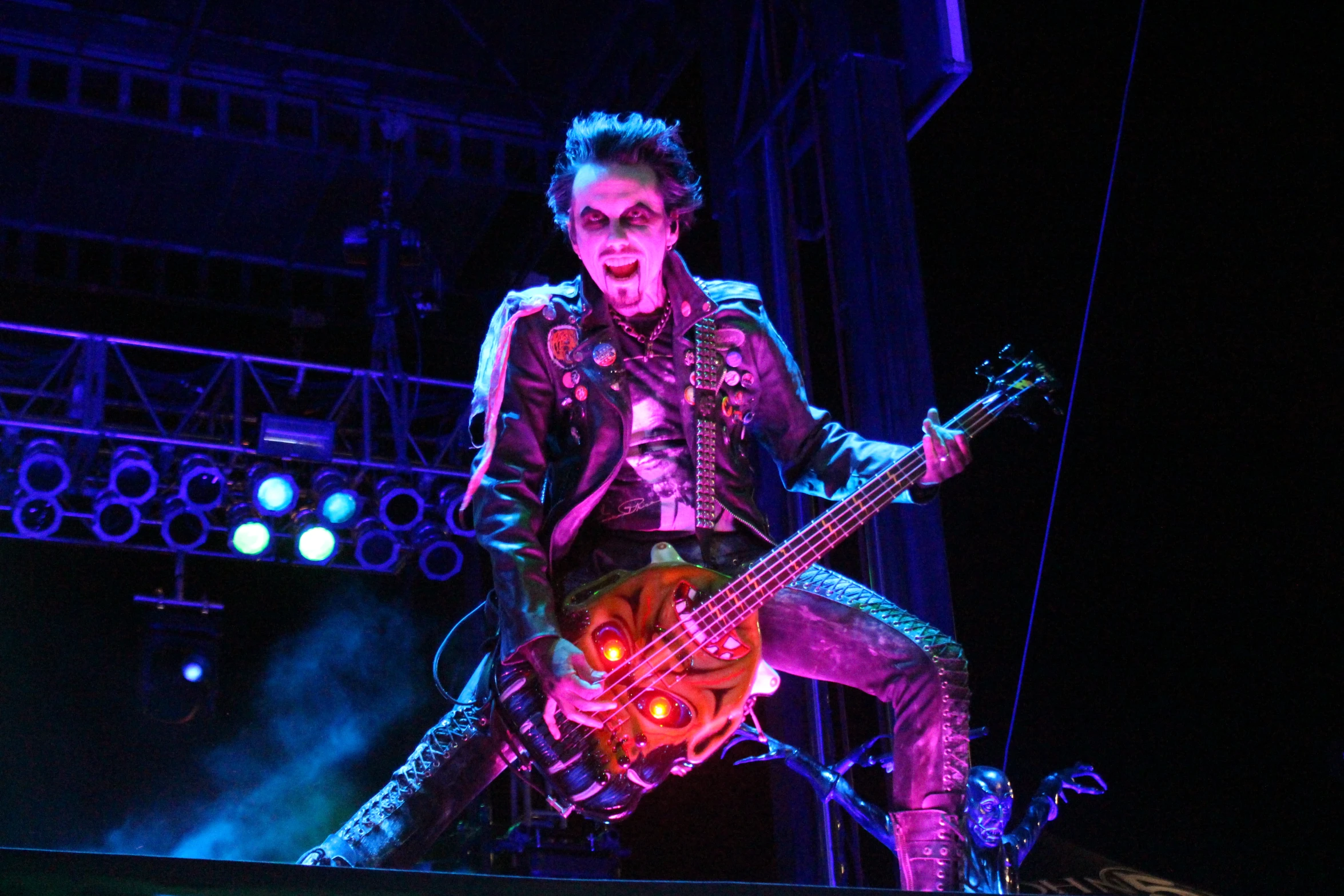 a man standing on top of a stage with a guitar