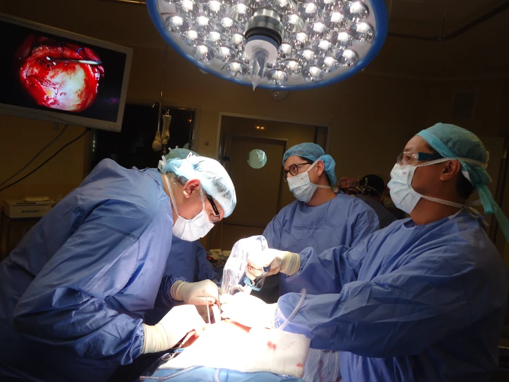 dental technicians working on a patient in the operating room