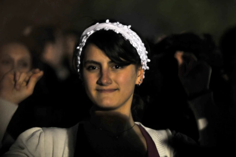 a woman in a flowery headband is shown smiling