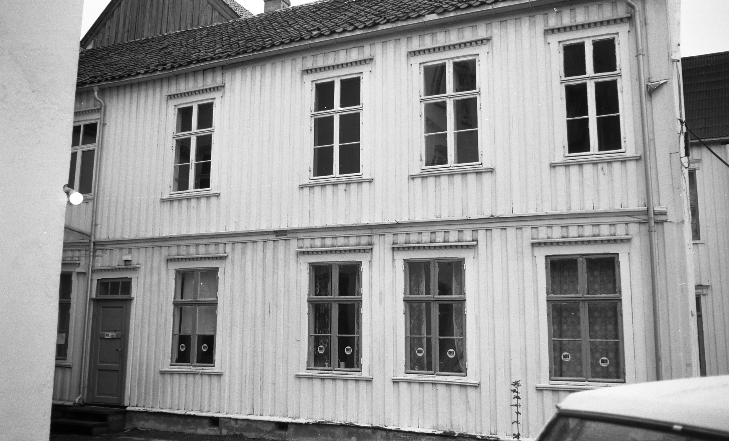 a building with windows sitting next to another building