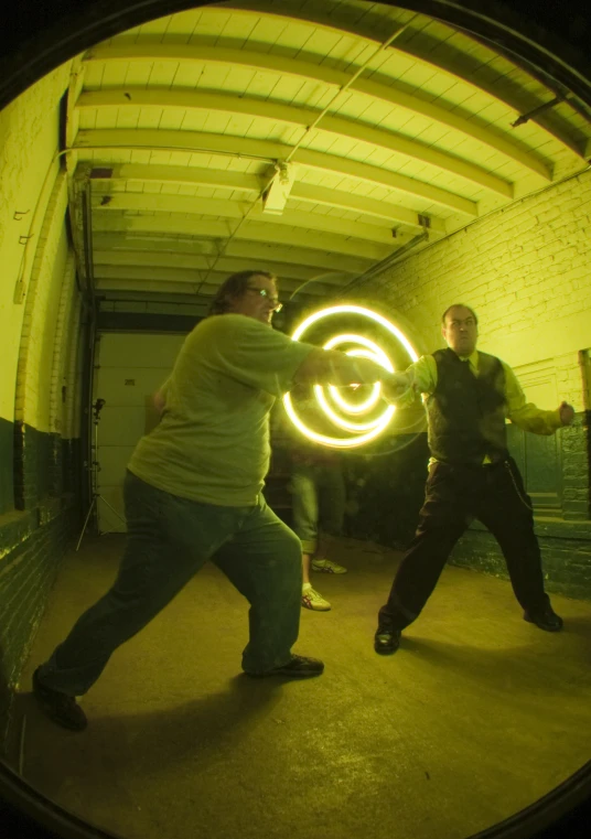 two guys in a building with some glowing light around