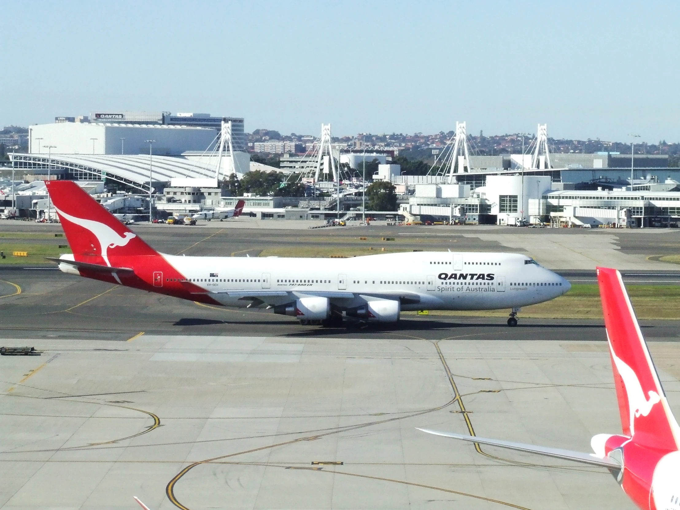 two airplanes are parked on the tarmac at an airport