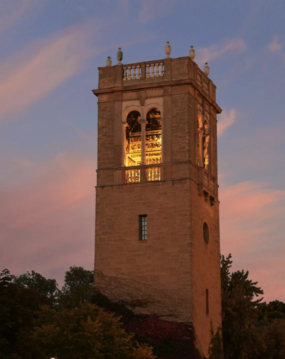 a bell tower that has the sun coming down