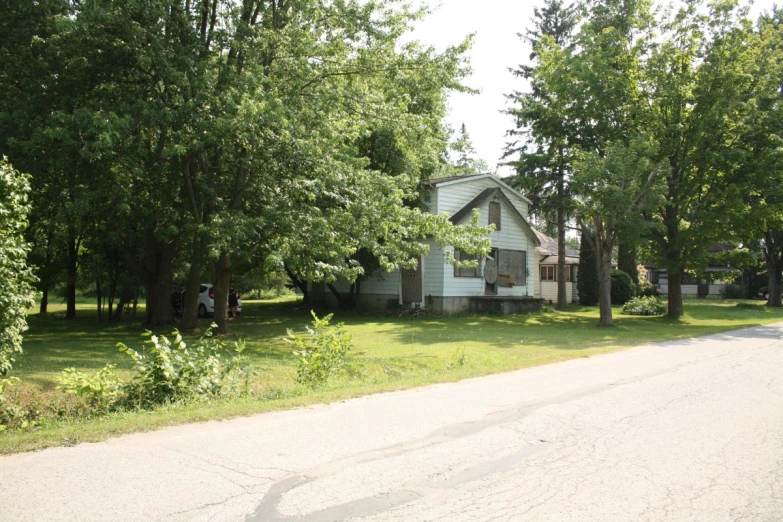 an old house sits along the side of a street