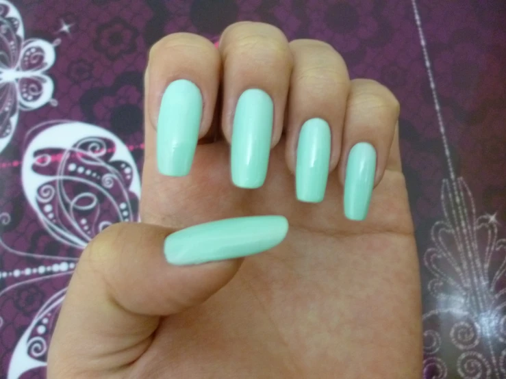 woman's nails showing bright green colors on top of her hand