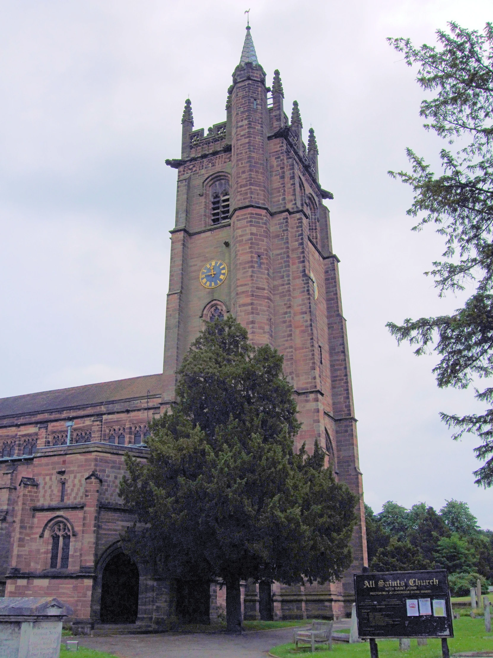 a tall building sitting on top of a lush green field