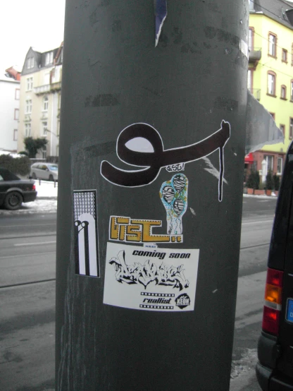 an image of stickers on the back of a street post