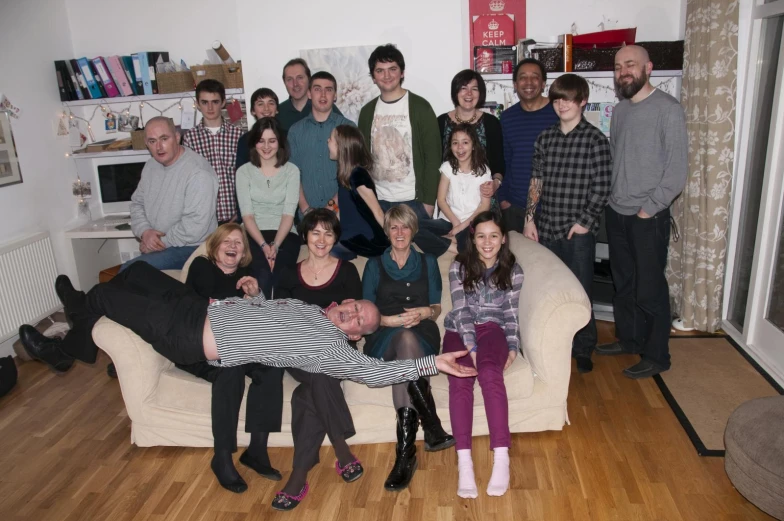 a group of people sitting around each other on a couch