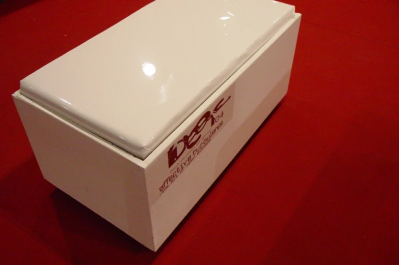 a white refridgerator on a red table