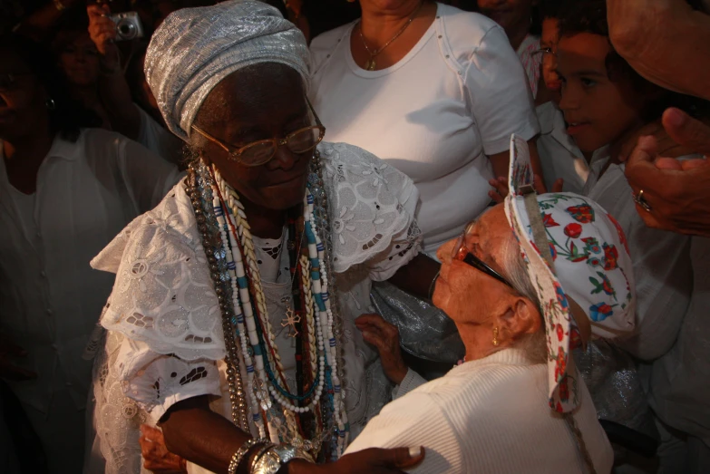 a women wearing a headpiece, necklaces and other items