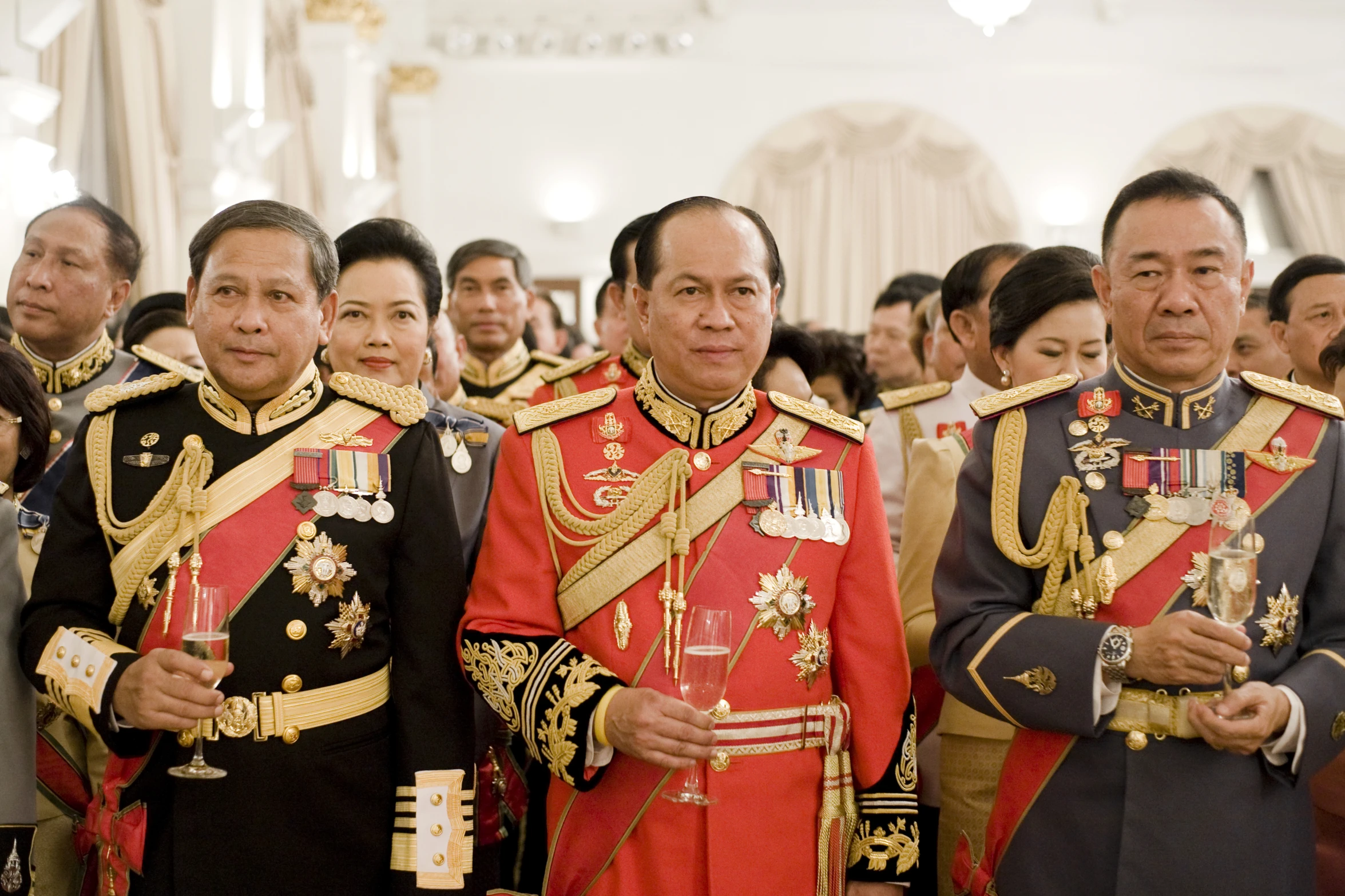 several men wearing ceremonial clothing are standing in a large room