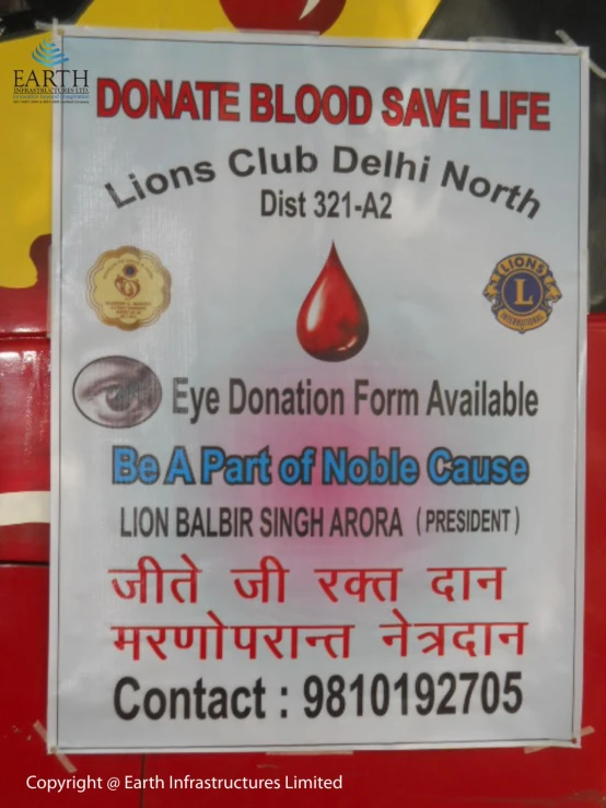 a donation sign that is on a red table