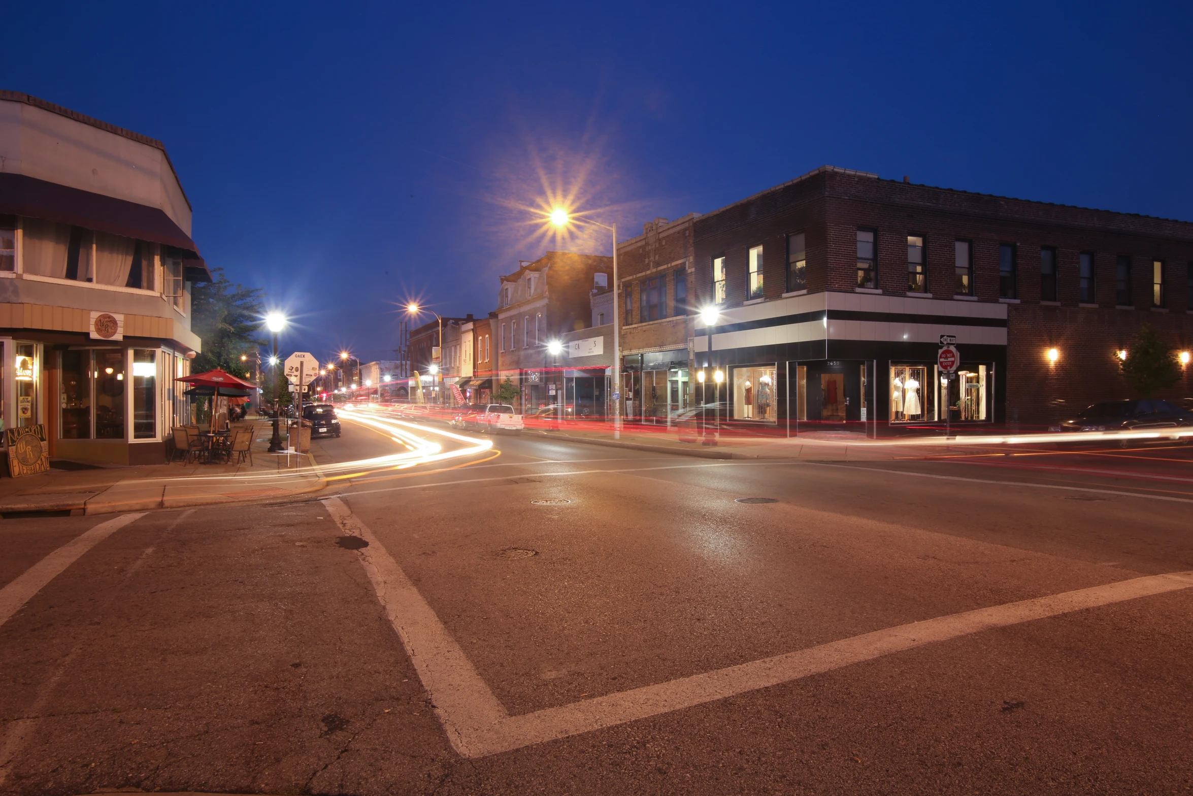 a city street with buildings lit up at night