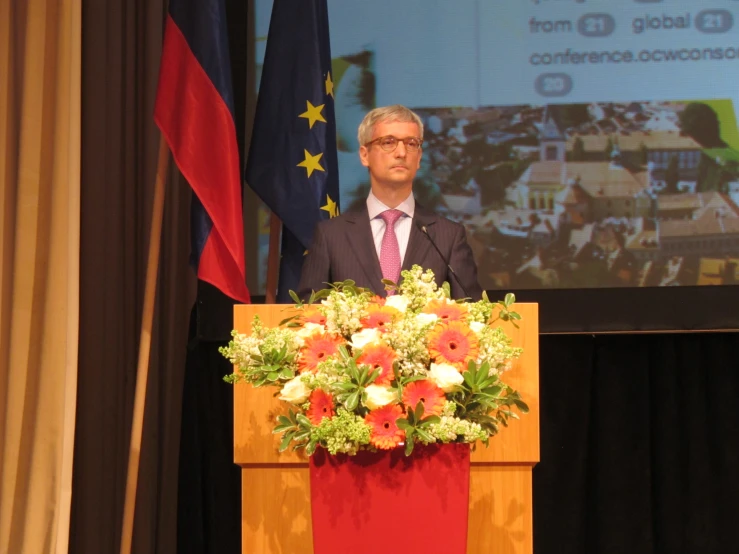 a man stands at a podium and gives a speech