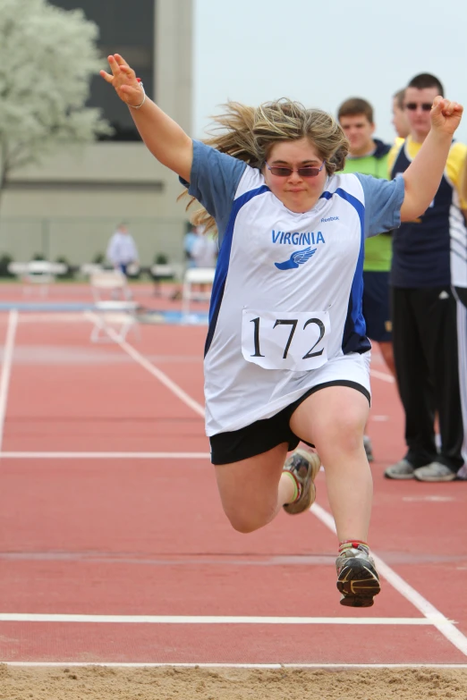 a woman that is jumping in the air with a shoe