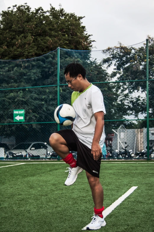 a man is preparing to kick a soccer ball on the field