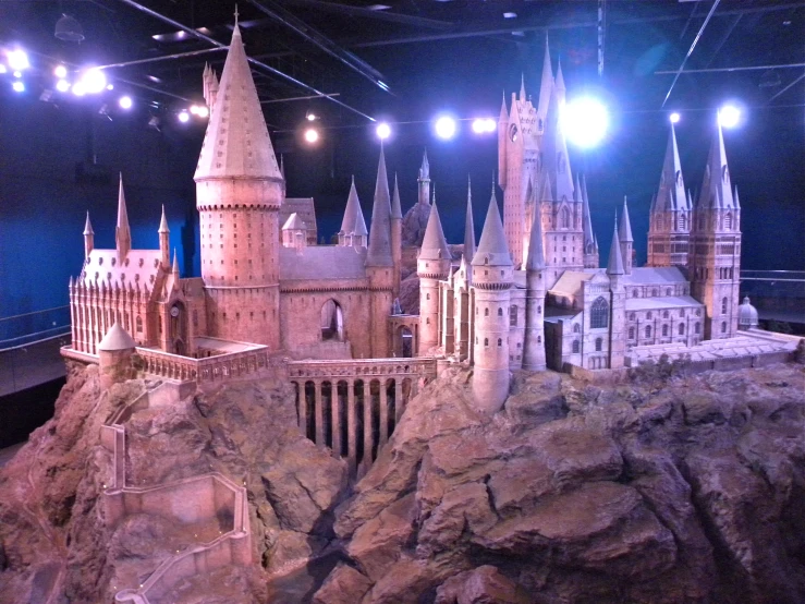 a model hogwart's castle sits on top of a mountain