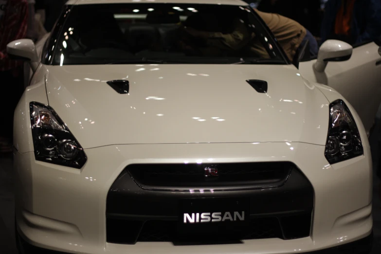 a white sports car is shown on display