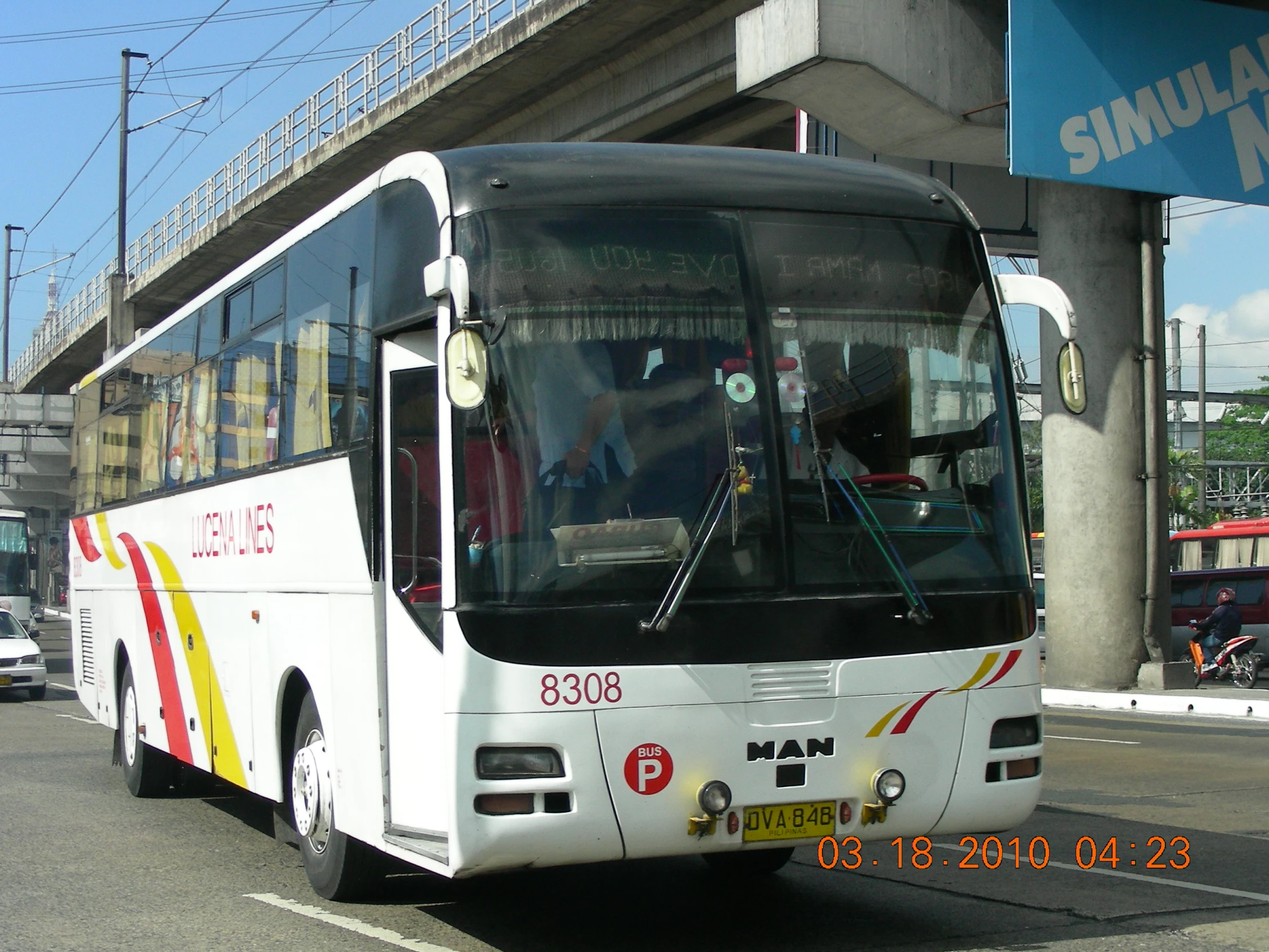 a white city bus traveling down a highway