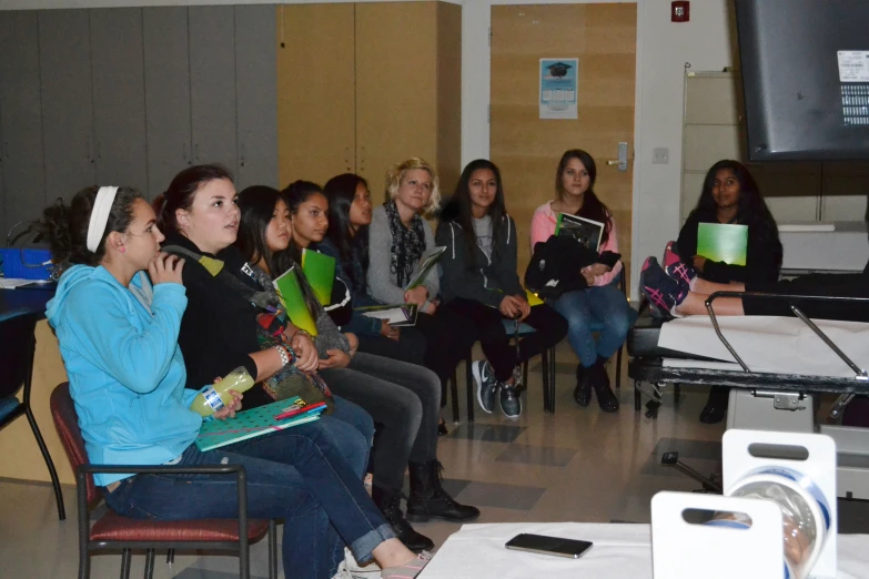 several women sitting and listening in the room