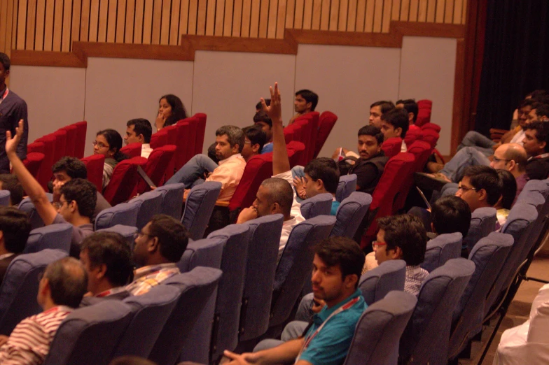 a group of people sitting in a auditorium