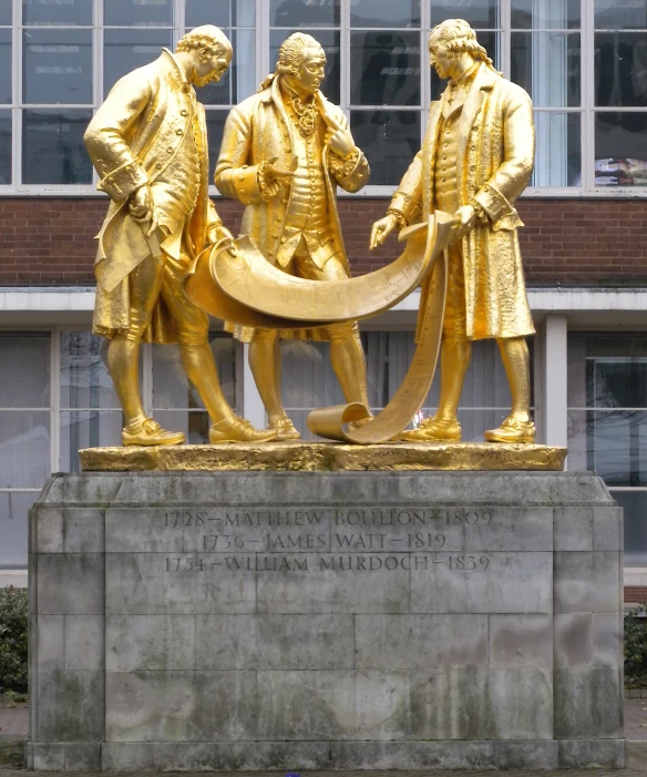 there are three golden statues holding an object