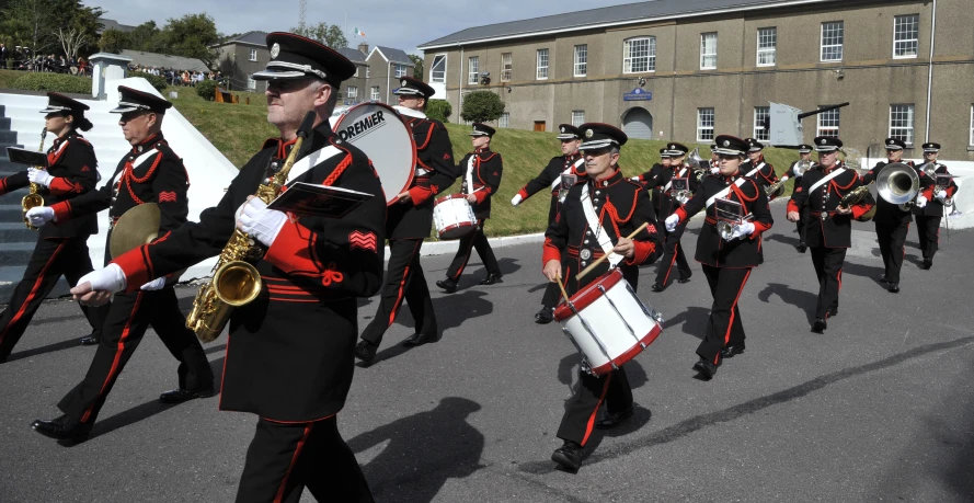 the military band is marching down the street