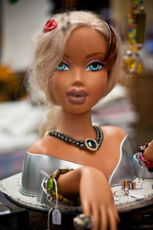 a doll wearing a tiara with bead celets