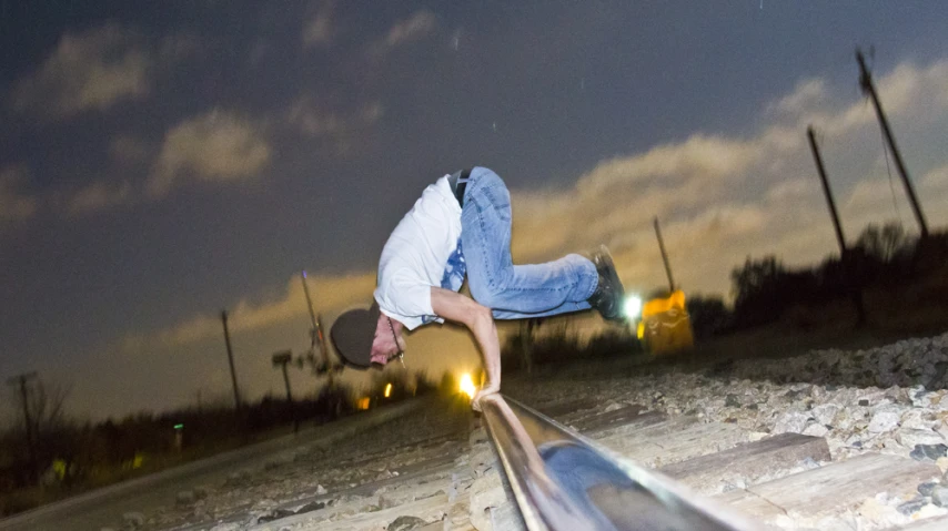 the young man is practicing his tricks on the rail