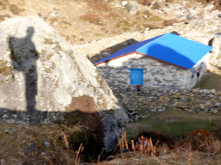 an old building sits between two huge rocks