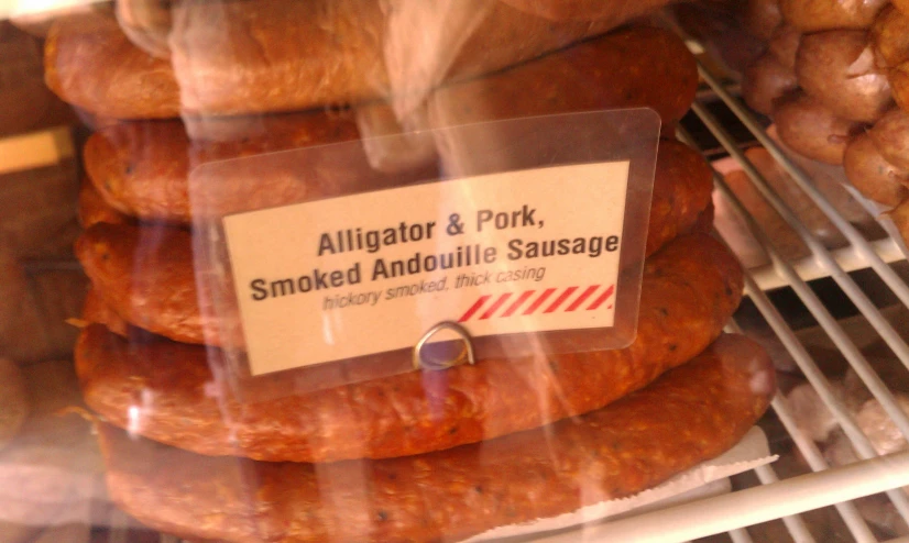 sausages for sale behind a display of racks of meats