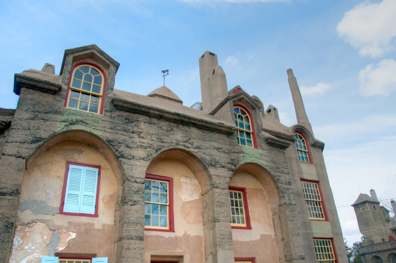 a large stone building with three windows