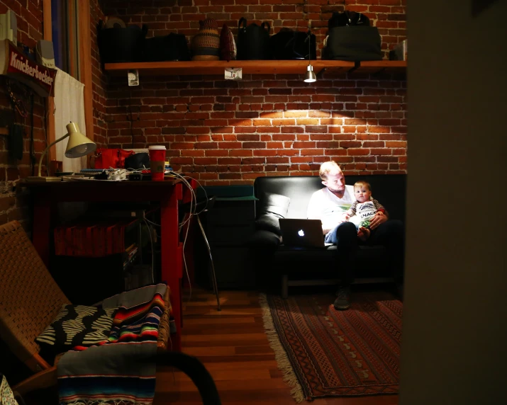 a living room has a little girl sitting on the couch