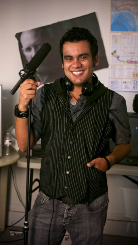 a guy standing with a microphone in his hand