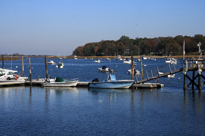 some boats are in the water near a dock
