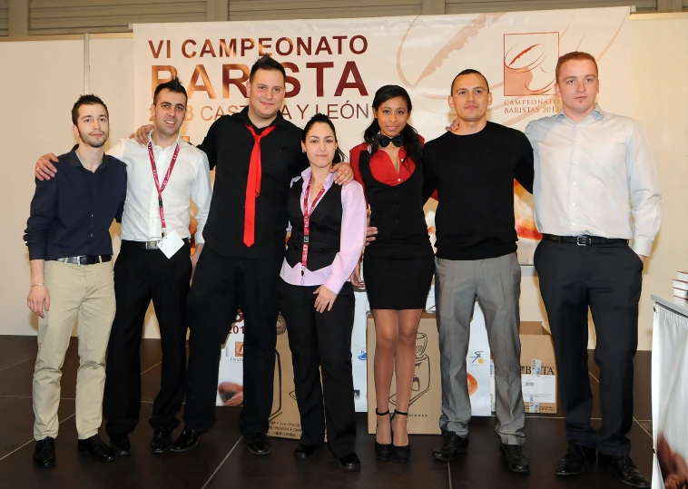 a group of people standing next to each other in front of a sign