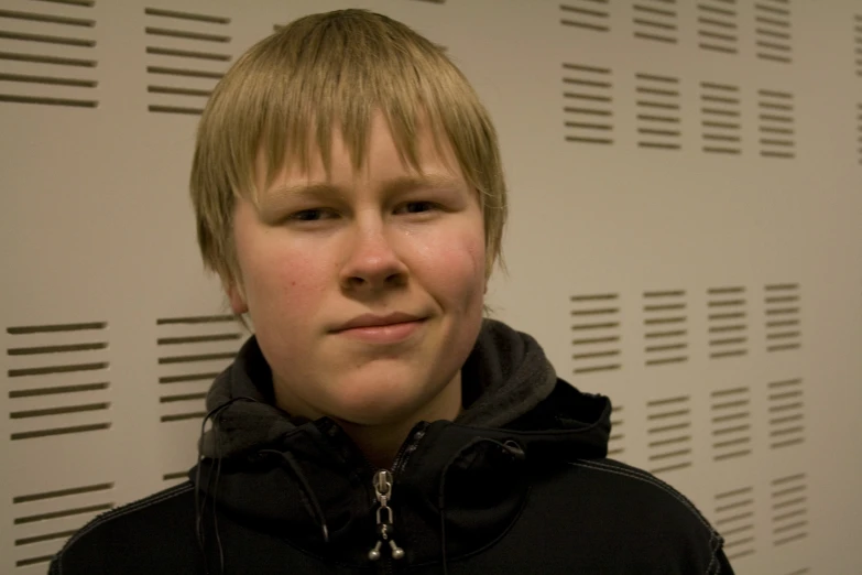 a boy in black jacket posing for picture