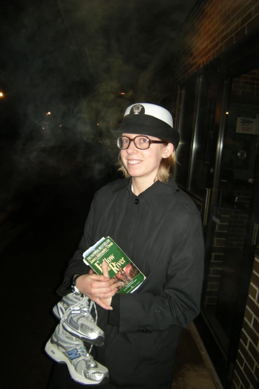 girl in black jacket and white hat holding book