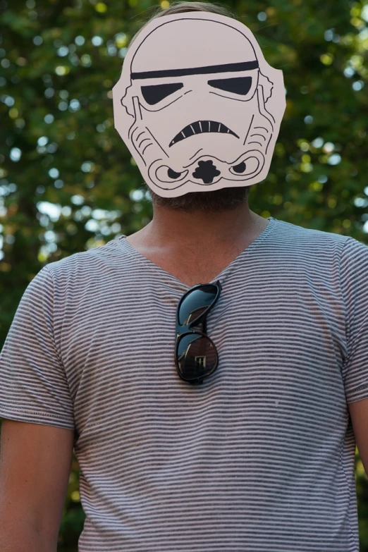 a man wearing a star wars helmet mask with glasses on it