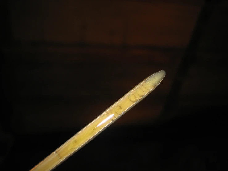 a wooden toothbrush in a dark room