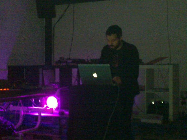 a man standing on the stage with a laptop