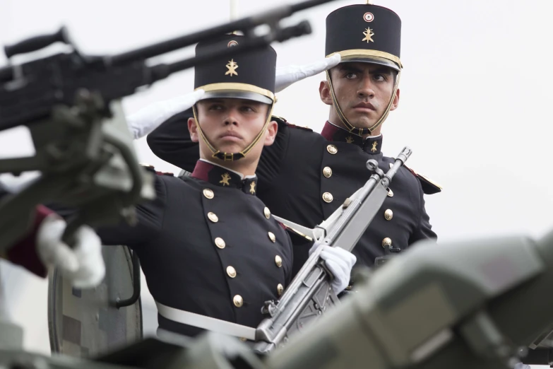 a couple of soldiers holding rifles near one another