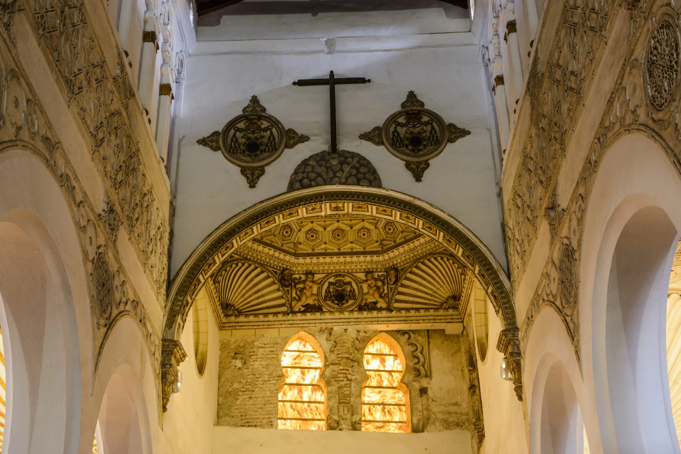 large open church with stone arches and stained glass windows