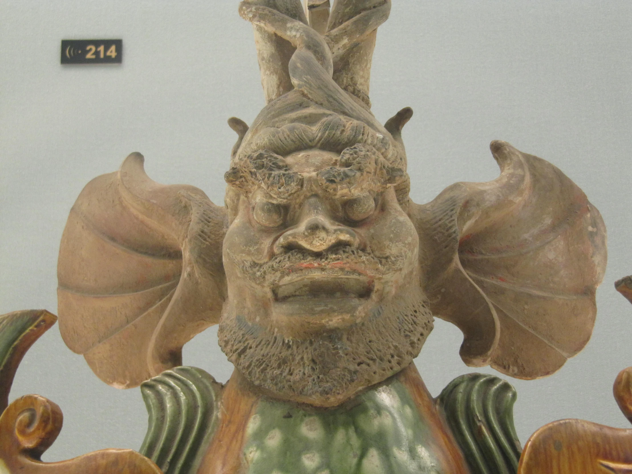 an artistic carving of an alien is shown on display