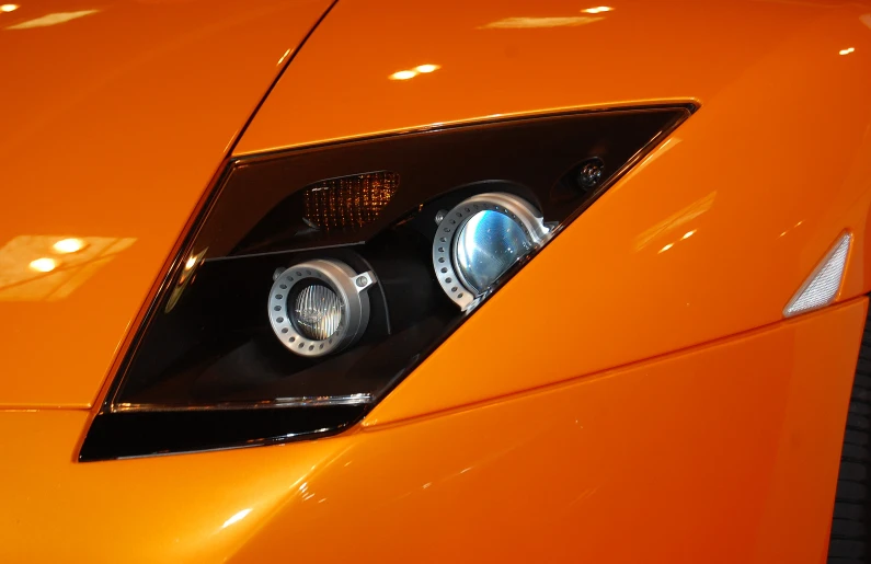 a orange car has two speakers attached to it