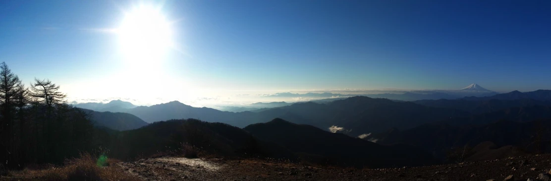 a view of a mountain range that is covered in clouds