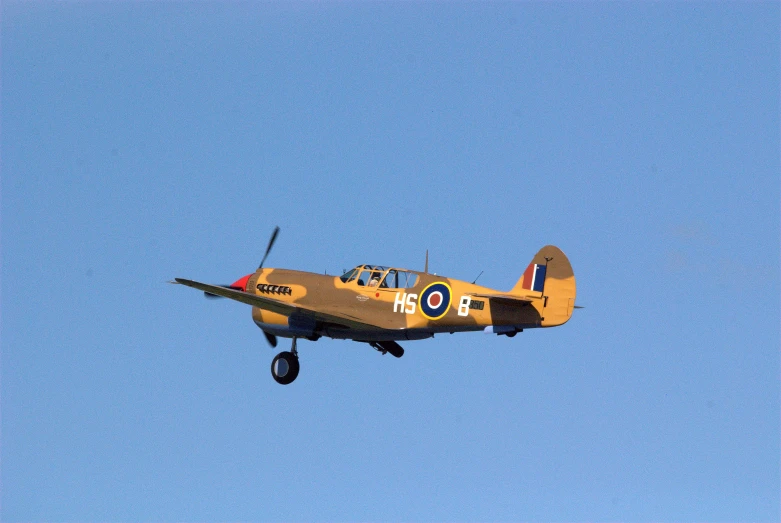 a small single engine propeller plane flying thru the air