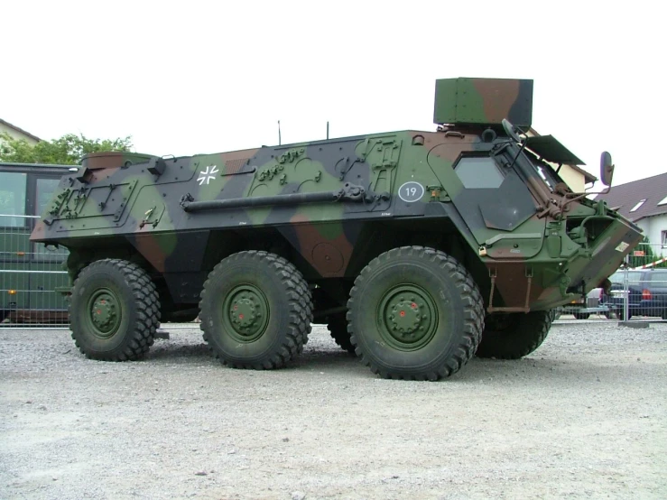 a close up of a military vehicle with many wheels