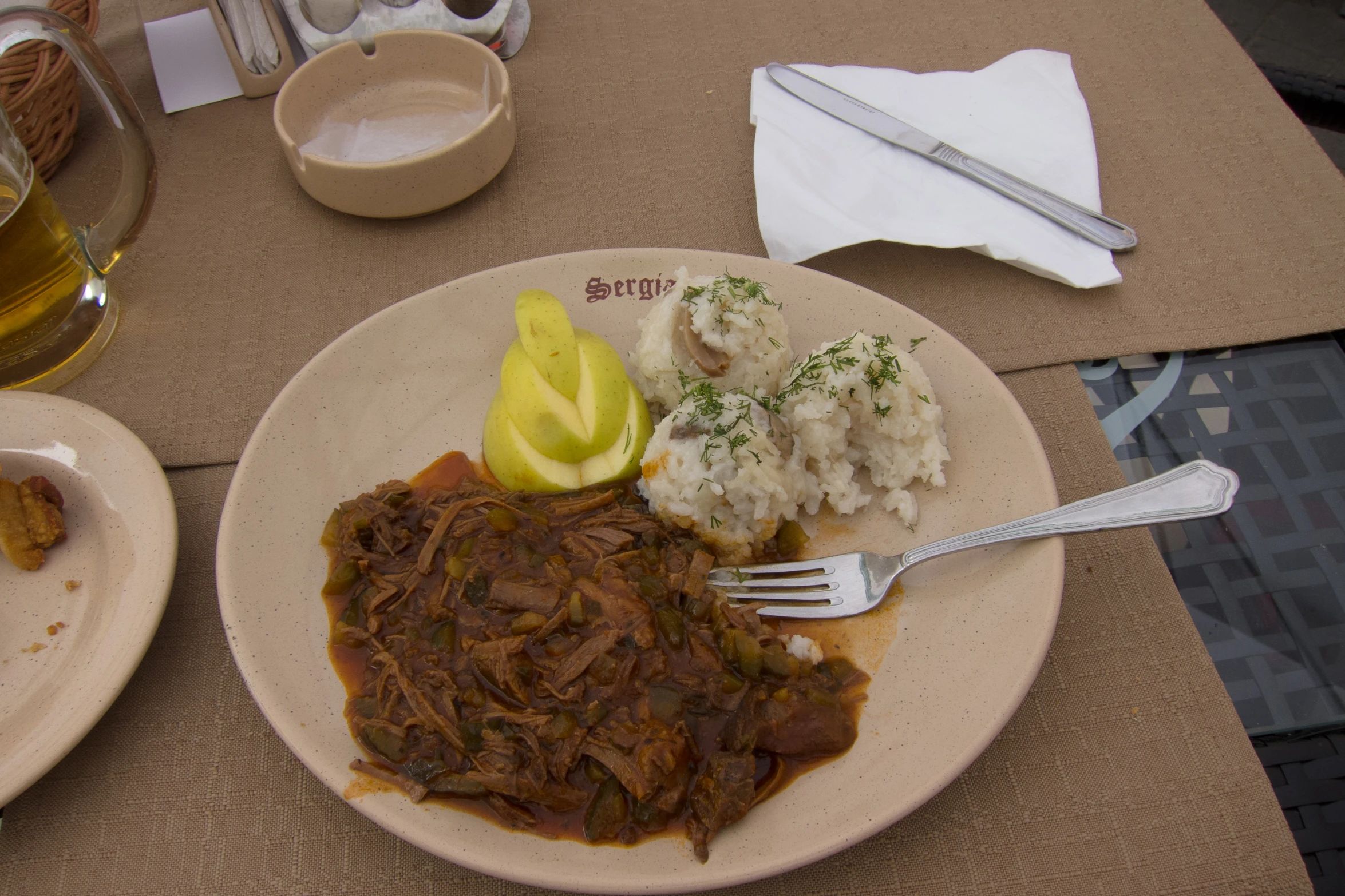 a dinner plate with steak, mashed potatoes and lemon